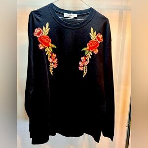 Use Top brand sweatshirt . Black color with a flower front design. Made in UK.